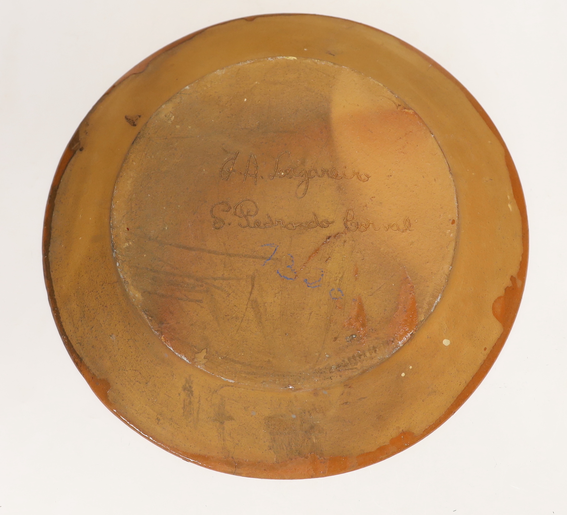 Two Portuguese glazed and incised pottery chargers, 36cm diameter